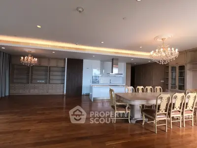 Luxurious open-plan living and dining area with elegant chandeliers and hardwood floors.
