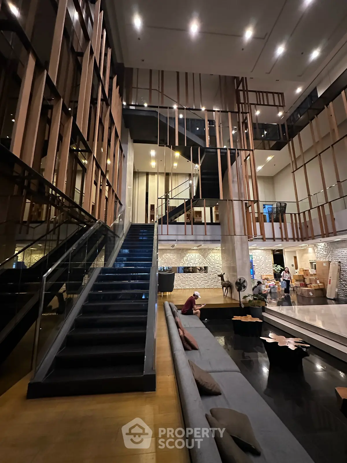 Luxurious modern building entrance with stylish staircase and seating area