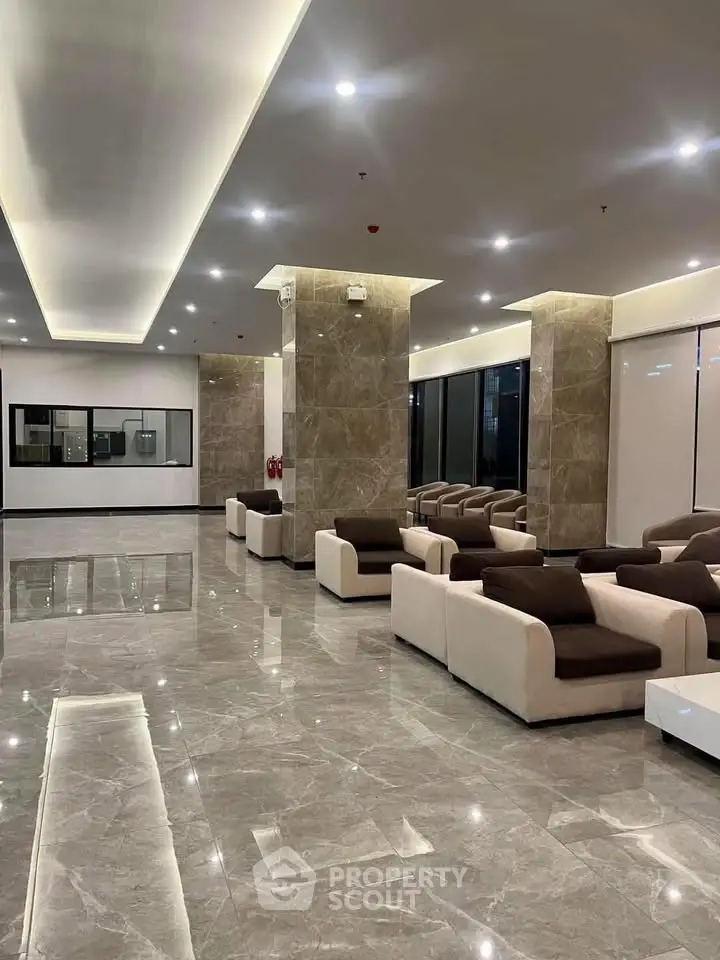 Luxurious modern lobby with elegant seating and marble flooring in a high-end building.