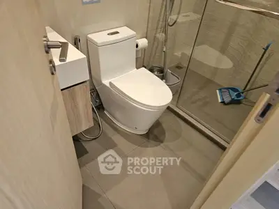Modern bathroom with sleek fixtures and glass shower enclosure, perfect for contemporary living.