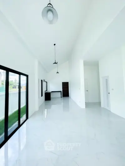 Spacious modern living room with high ceilings and large windows