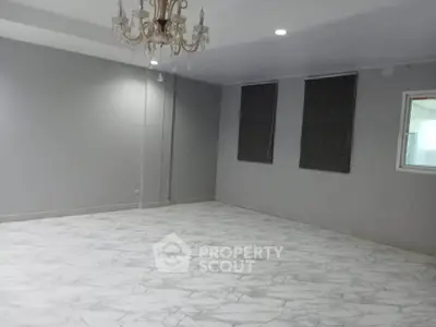 Spacious living room with elegant chandelier and marble flooring