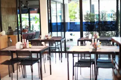 Spacious dining area with modern decor and ample natural light, perfect for gatherings.