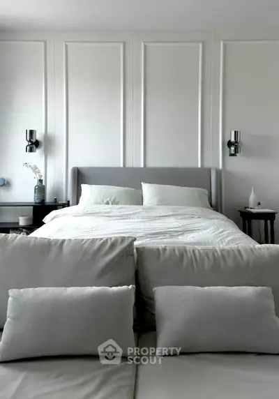 Luxurious bedroom with elegant paneling and plush bedding, perfect for relaxation and comfort.