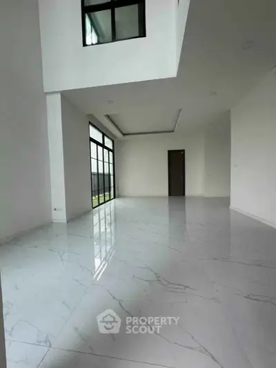 Spacious modern living room with marble flooring and large windows