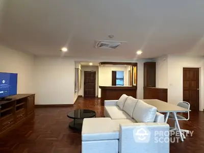 Spacious living room with modern furniture and open layout, perfect for family gatherings.