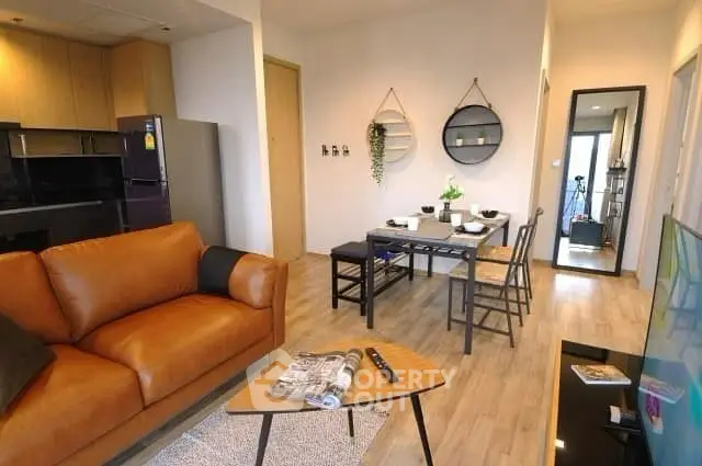 Modern living room with stylish decor and open dining area in a cozy apartment.
