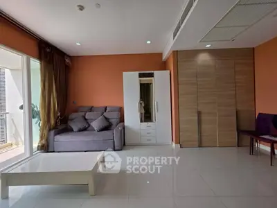 Spacious living room with modern furniture and large windows for natural light.