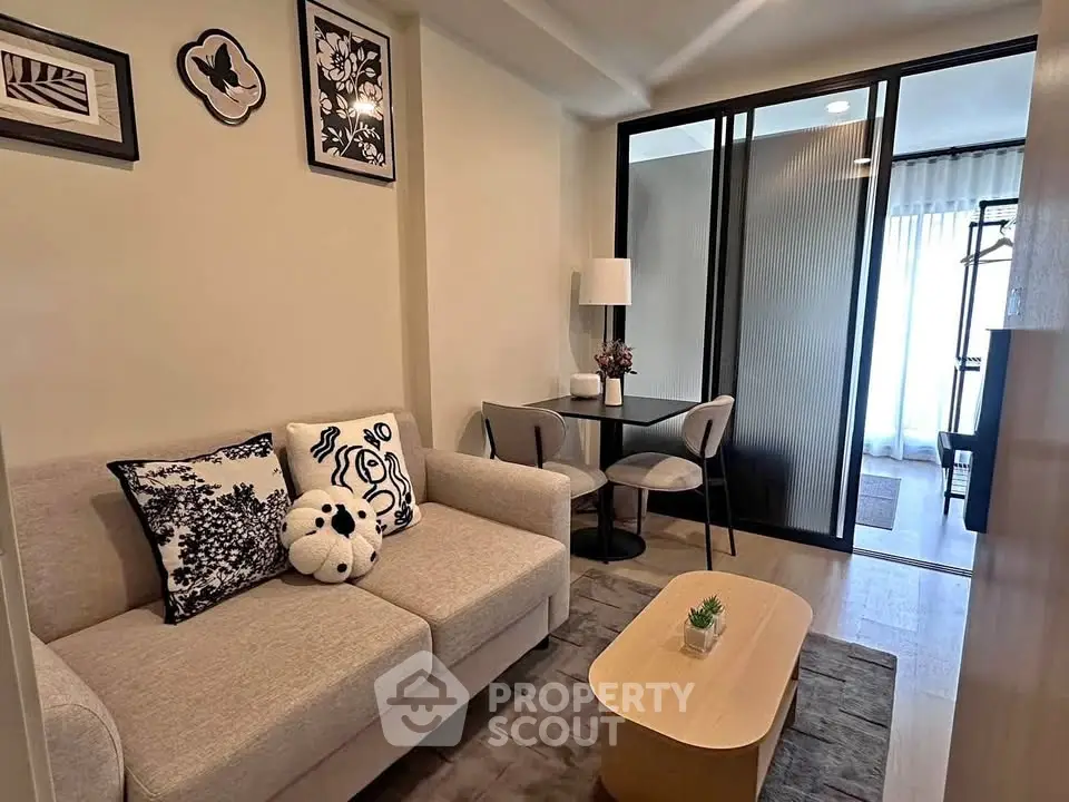 Modern living room with cozy sofa and stylish decor in open layout apartment.