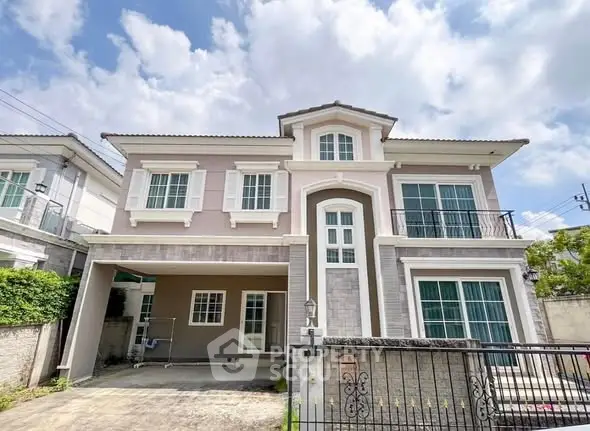 Elegant two-story house with spacious driveway and modern design under a clear blue sky.