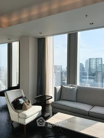 Luxurious living room with panoramic city view and modern furniture.