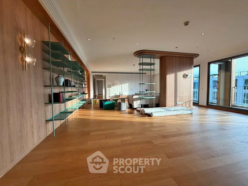 Spacious modern living room with wooden floors and stylish shelving