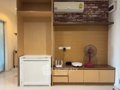 Modern living room with built-in wooden shelves and air conditioning unit
