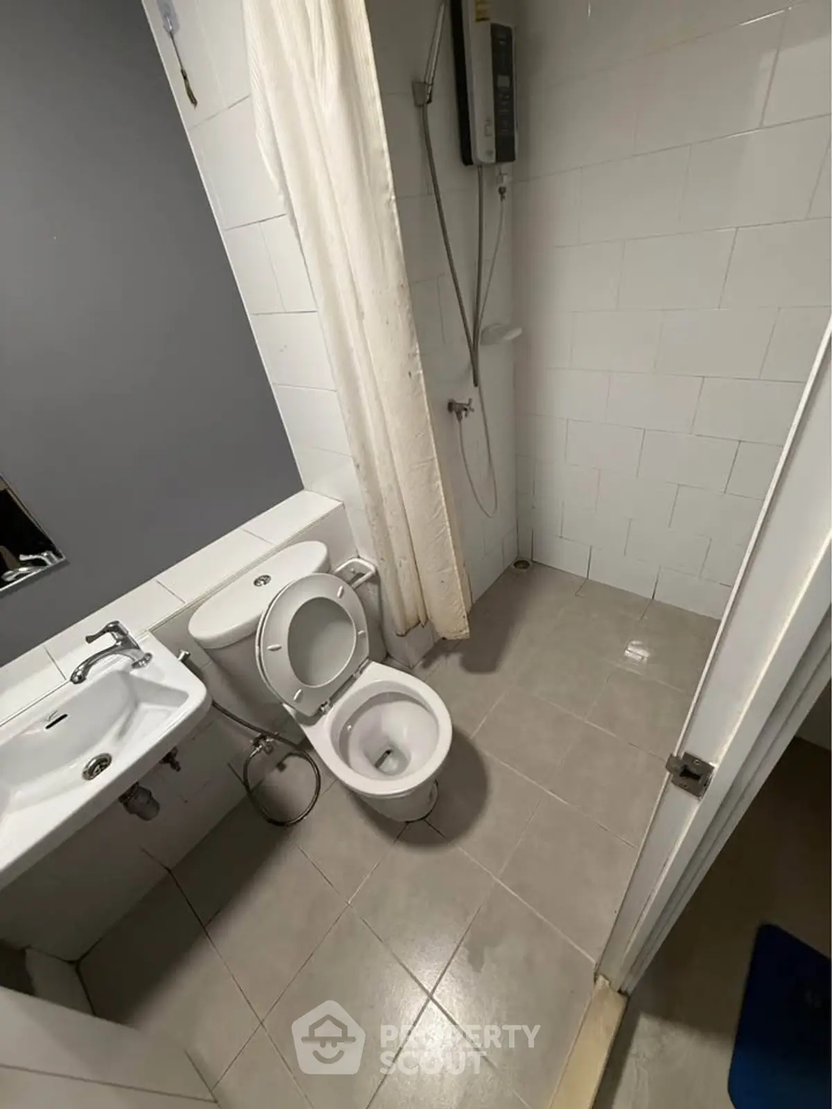 Compact bathroom with modern fixtures and shower area