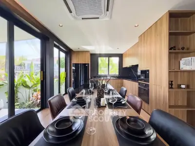 Modern dining area with elegant table setting and open kitchen layout