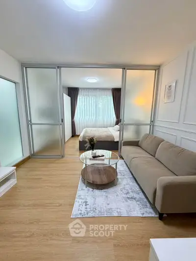 Modern studio apartment with sliding glass doors and cozy furnishings