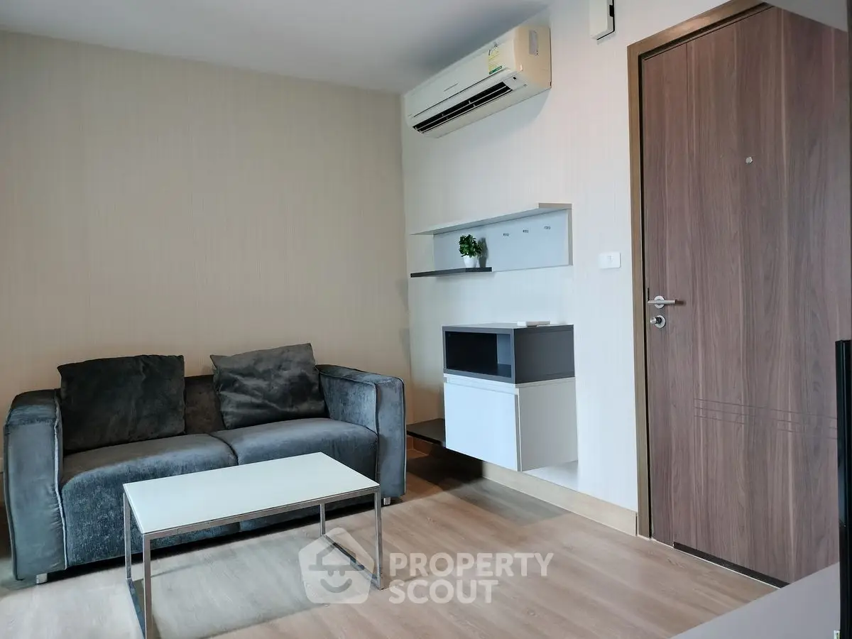 Modern living room with sleek furniture and air conditioning