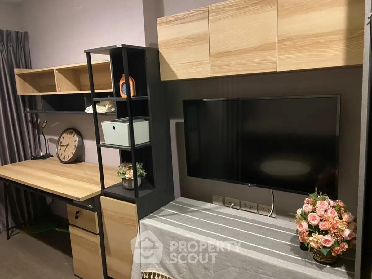 Modern study room with stylish wooden desk and wall-mounted TV, perfect for productivity and relaxation.