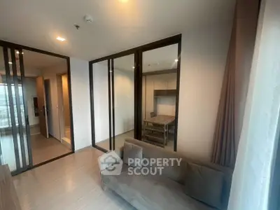 Modern living room with glass partitions and cozy sofa in a stylish apartment