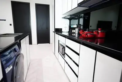Modern kitchen with sleek black and white cabinetry and built-in appliances