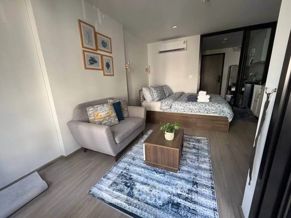 Modern studio apartment with cozy living area and stylish decor