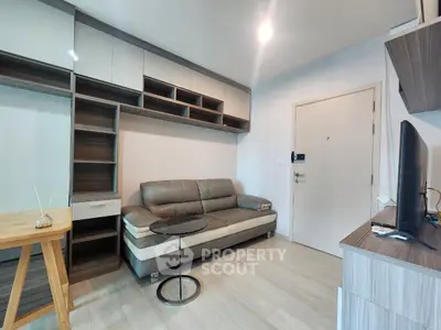 Modern living room with sleek furniture and built-in storage in a stylish apartment.