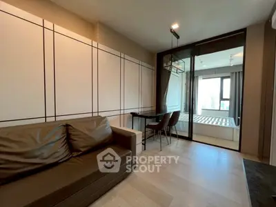 Modern apartment interior with cozy living area and glass partitioned bedroom.
