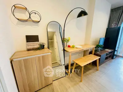 Modern living room with stylish furniture and decor, featuring a sleek floor lamp and wooden table.