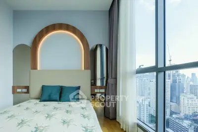 Modern bedroom with city view and stylish decor in high-rise apartment