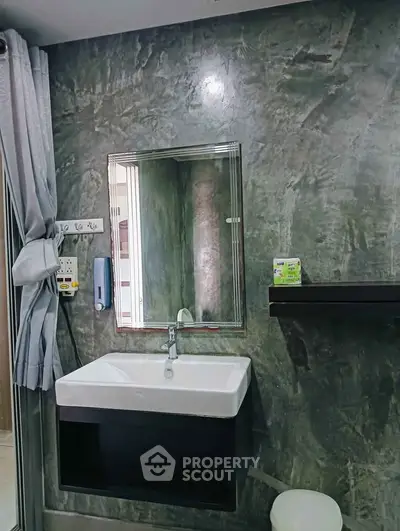 Modern bathroom with sleek sink and mirror, featuring contemporary design and stylish finishes.