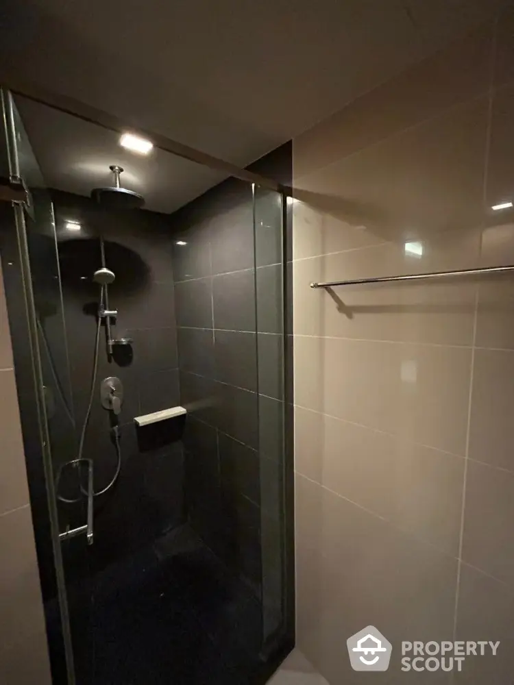 Modern bathroom with sleek glass shower enclosure and elegant tile design