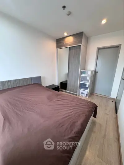 Modern bedroom with sleek design and ample storage in a stylish apartment.