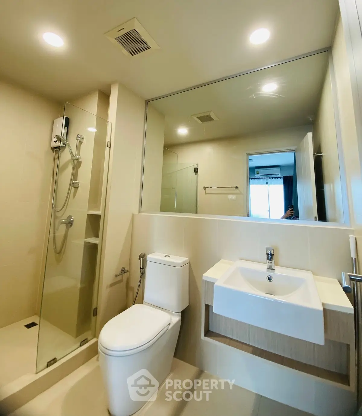 Modern bathroom with glass shower and sleek fixtures in a contemporary home.