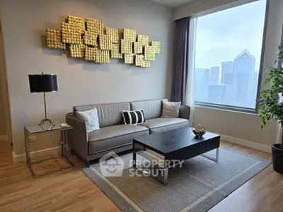Modern living room with stylish decor and city view, featuring a sleek sofa and contemporary art piece.