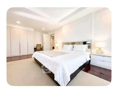 Spacious modern bedroom with elegant decor and ample natural light