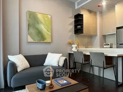 Modern living room with cozy sofa and stylish kitchen area, perfect for urban living.