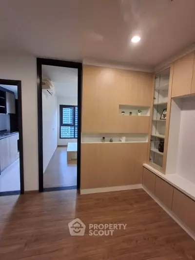 Modern apartment interior with wooden flooring and built-in shelving