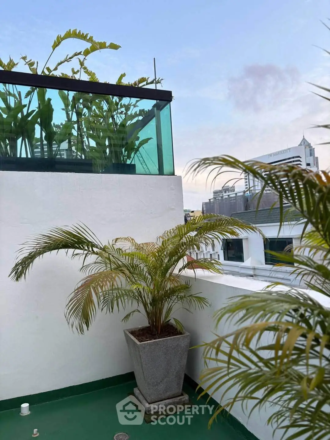 Charming rooftop terrace with lush greenery and city views, perfect for relaxation and entertaining.