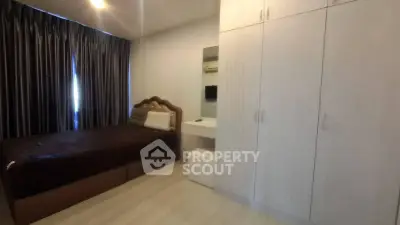 Cozy bedroom with elegant bed, spacious wardrobe, and stylish curtains in modern apartment.