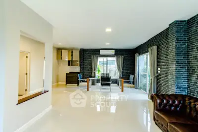 Spacious modern living room with sleek design and large windows for natural light.