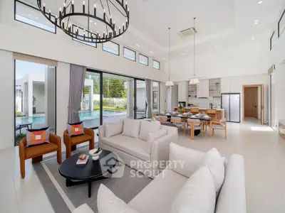 Luxurious open-plan living room with pool view, modern furniture, and elegant lighting in a contemporary home.