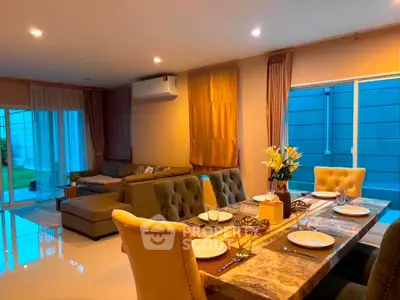 Luxurious open-plan living and dining area with elegant decor and ample natural light.