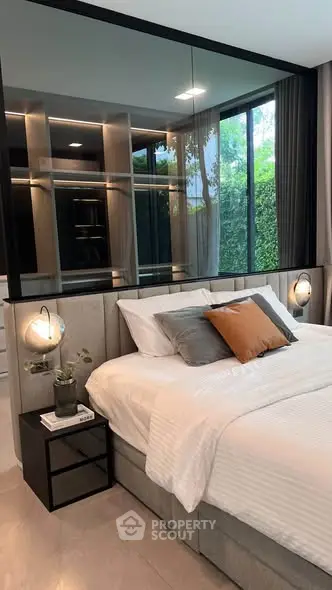 Luxurious modern bedroom with elegant decor and large window view.