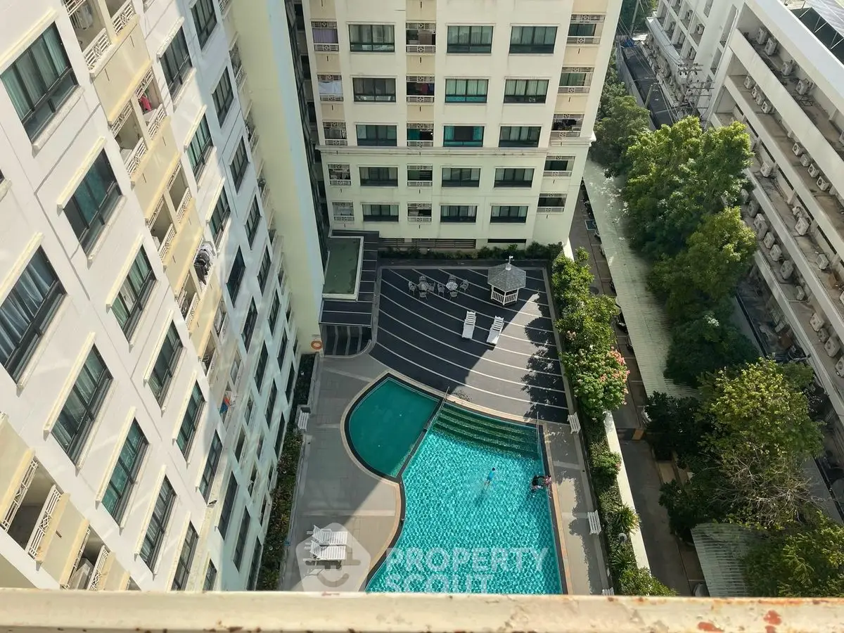 High-rise apartment view with swimming pool and landscaped courtyard