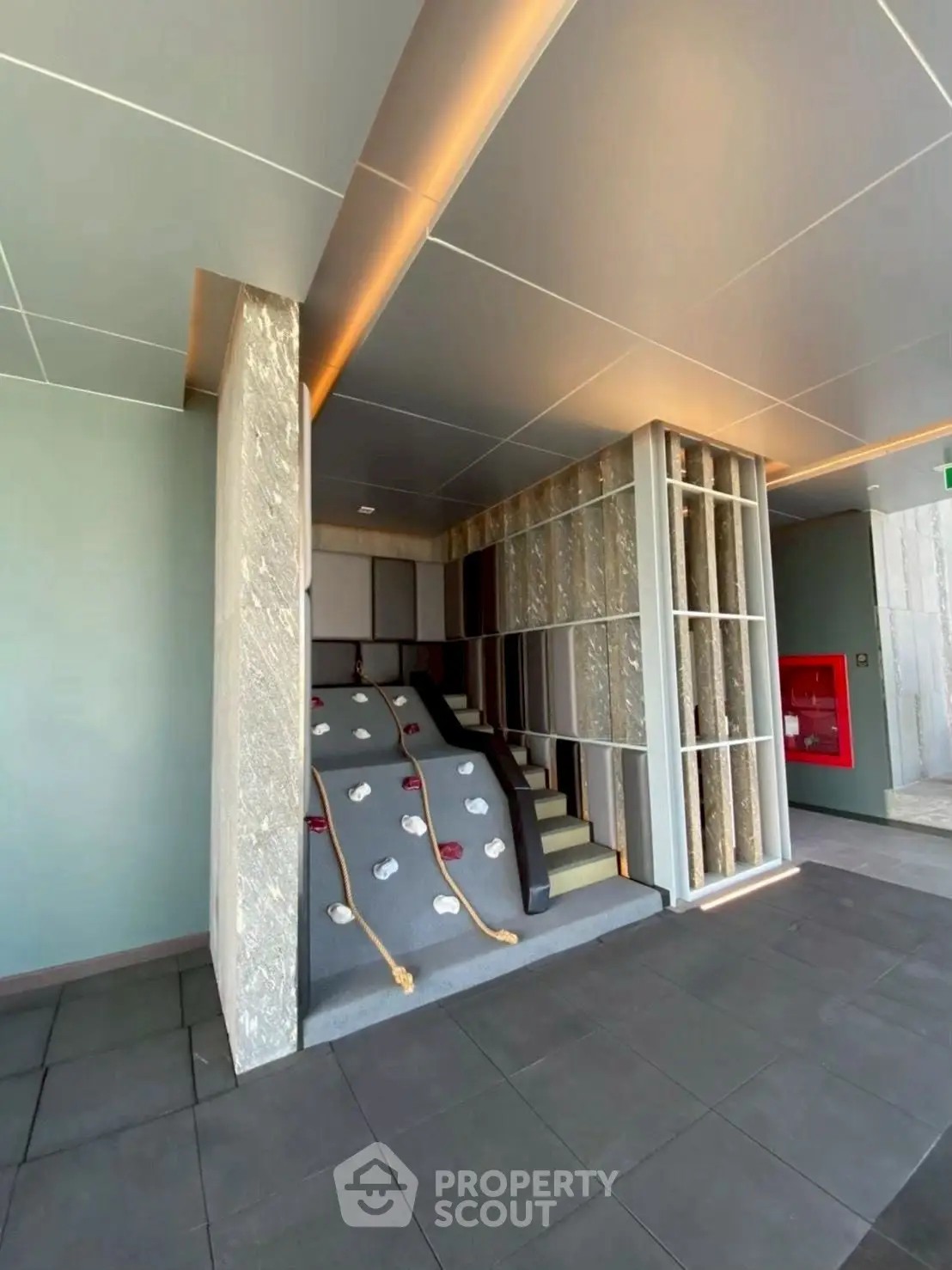 Modern building entrance with unique architectural design and stylish lighting
