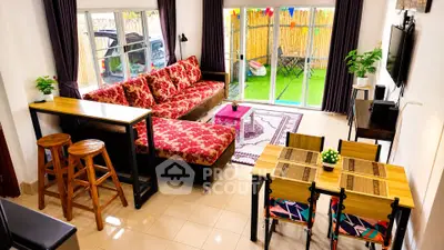 Vibrant living room with colorful decor and garden view, perfect for modern family living.