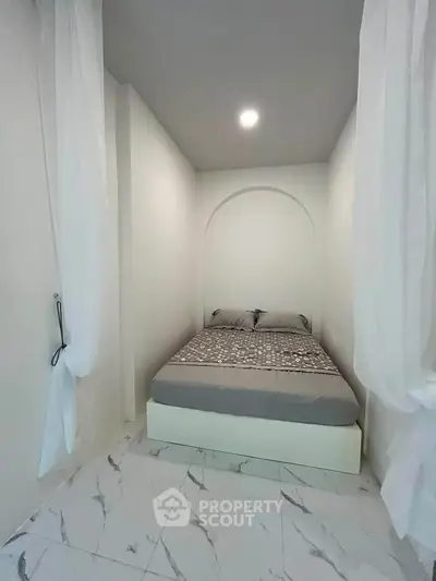 Cozy minimalist bedroom with elegant marble flooring and soft lighting