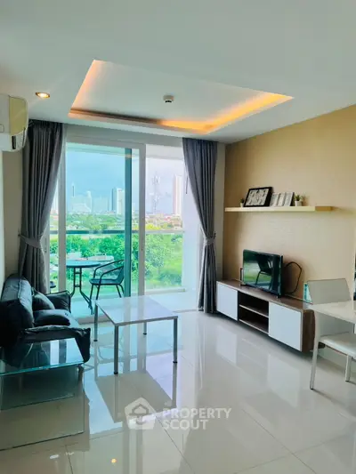 Modern living room with balcony and city view, featuring sleek furniture and natural light.