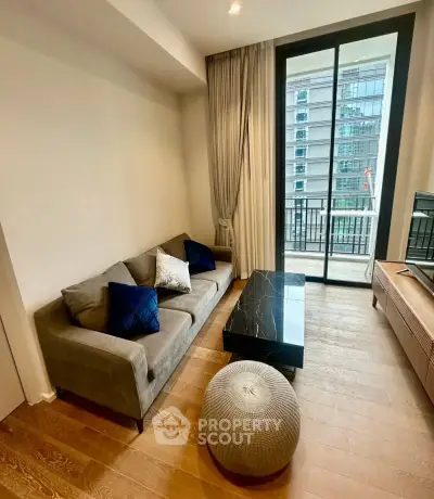 Modern living room with elegant decor and city view balcony access