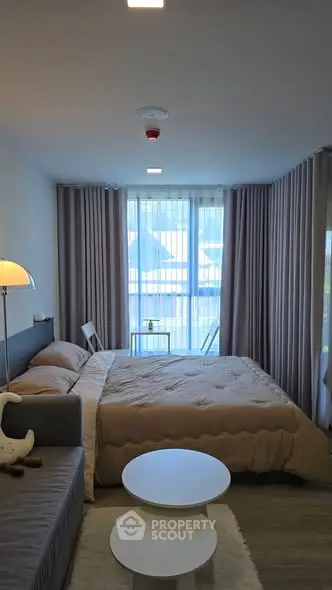 Modern bedroom with large windows and stylish decor